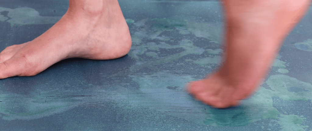 The image shows the palms of Helen’s hands covered in bright orange turmeric powder.. turmeric powder can be added to the chemicals on the paper to archive unusual colours and marks during the exposure.